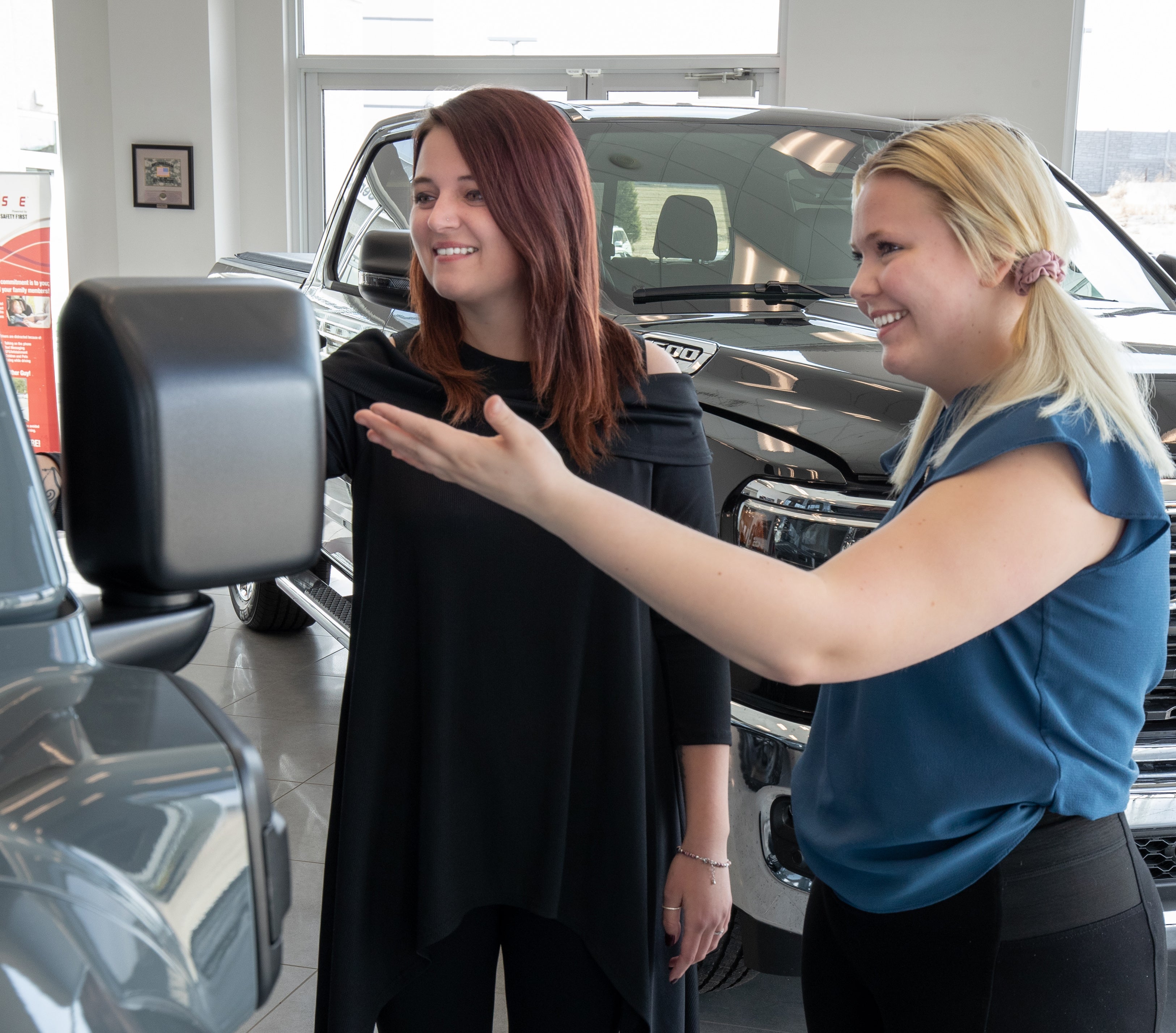 Salesperson showing a vehicle on the showfloor